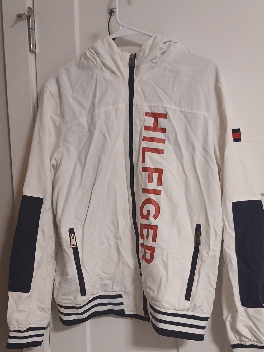 Tommy Hilfiger nylon windbreaker jacket featuring a large vertical HILFIGER. M